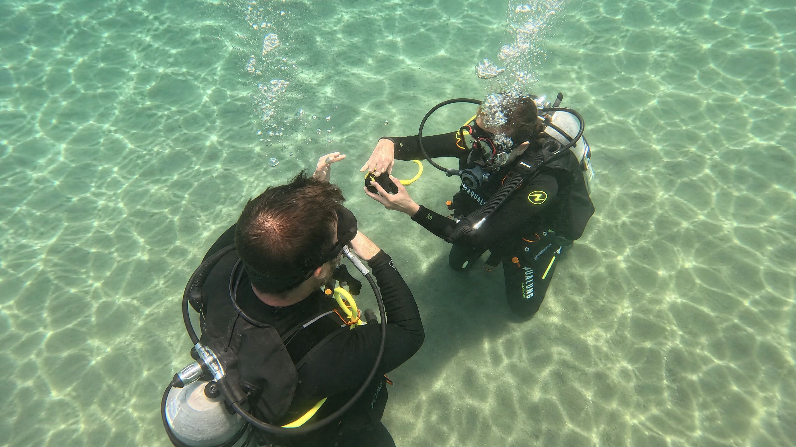 Instructor and student working a skill on the sand