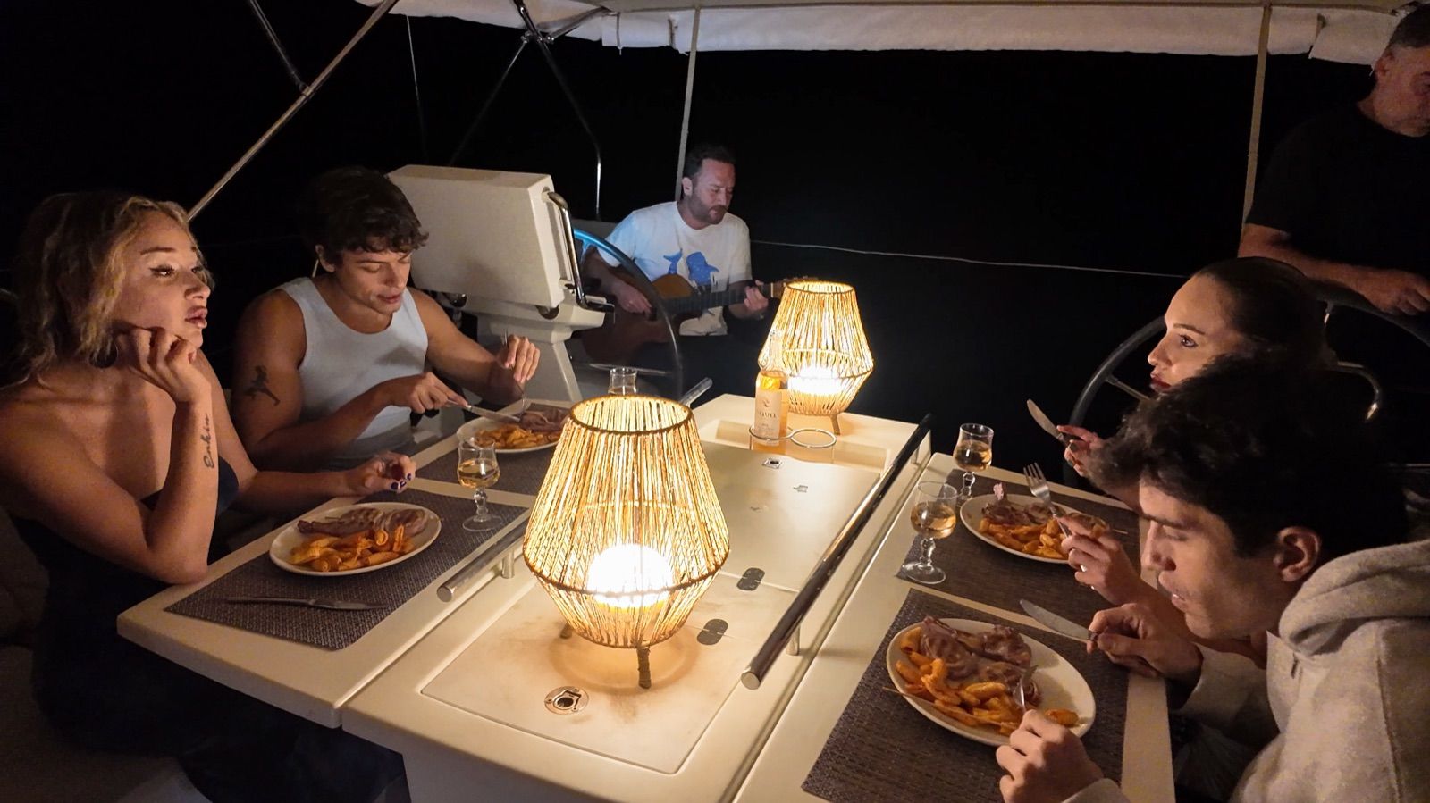 Dinner in the cockpit, guitar at the helm