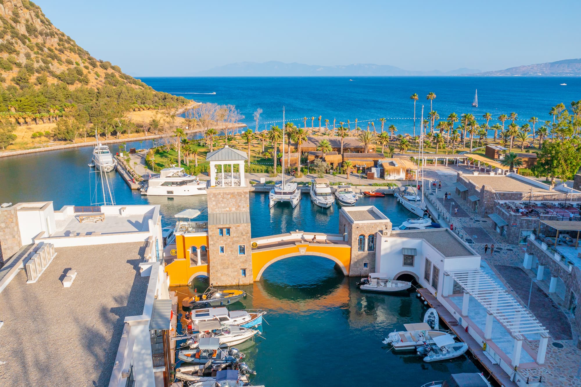 Anthaven marina on Aspat Bay from the air, the hill behind and the Aegean beyond