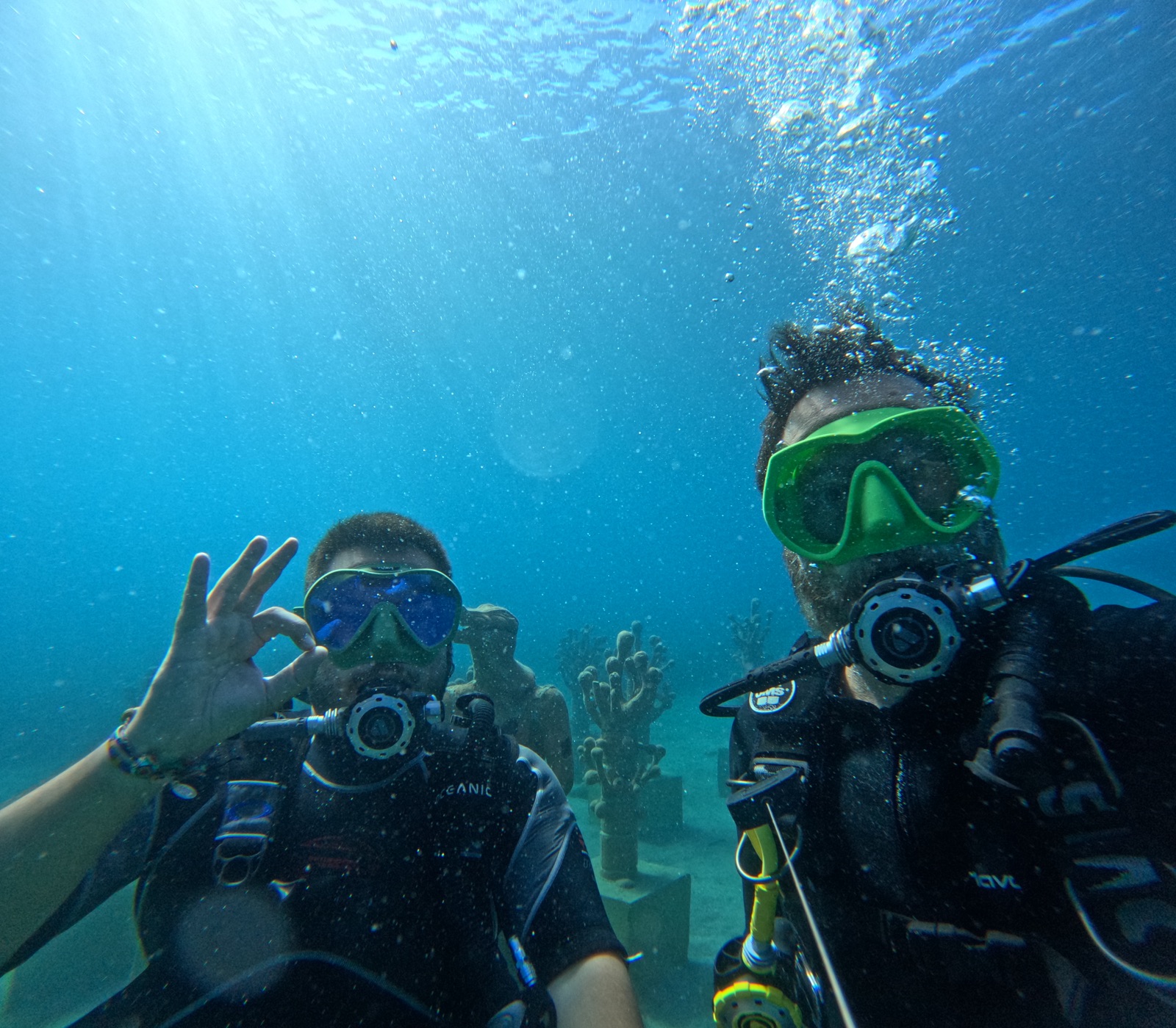First-time diver giving double peace signs on the seabed