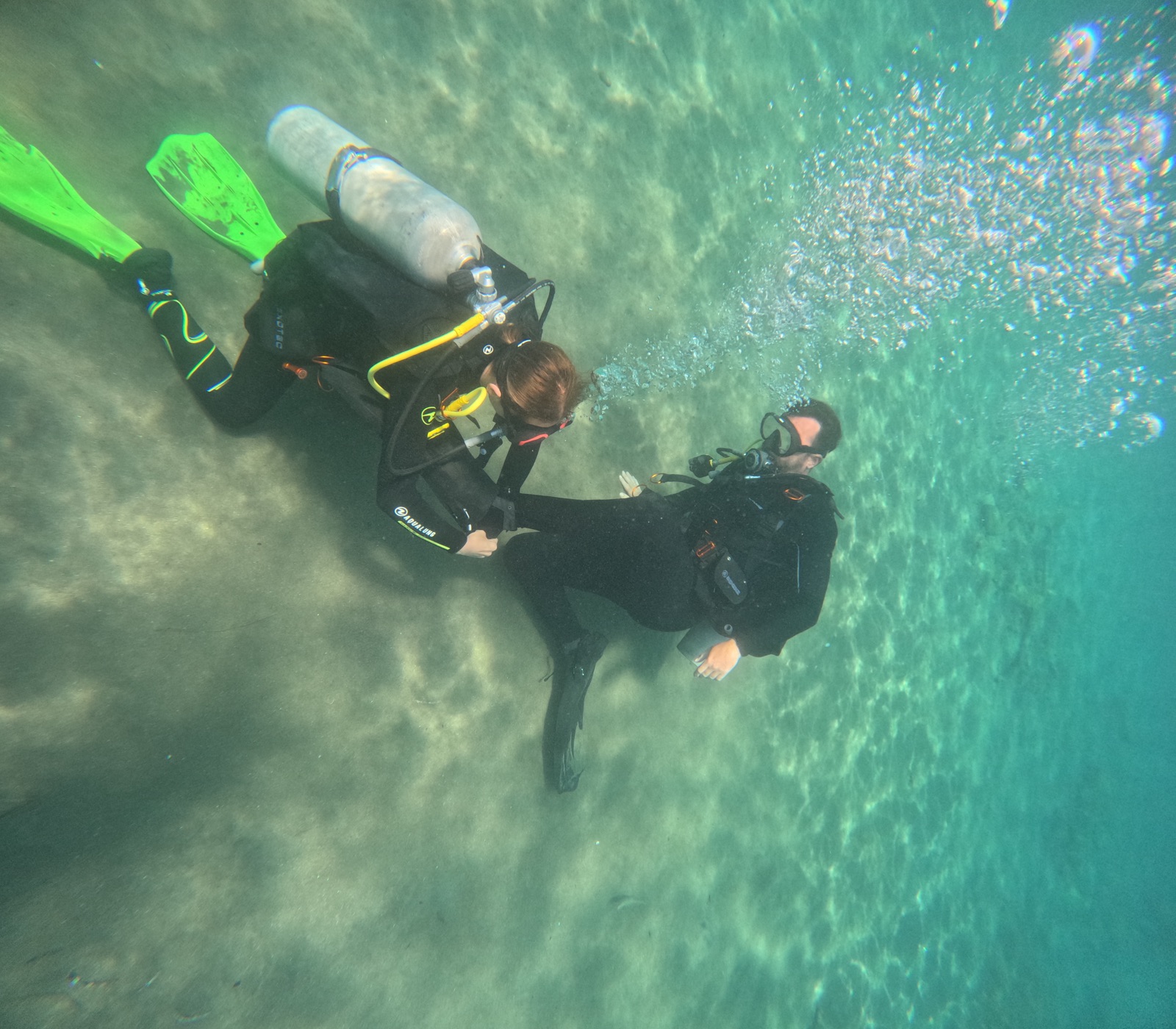 Instructor guiding a student's first swim