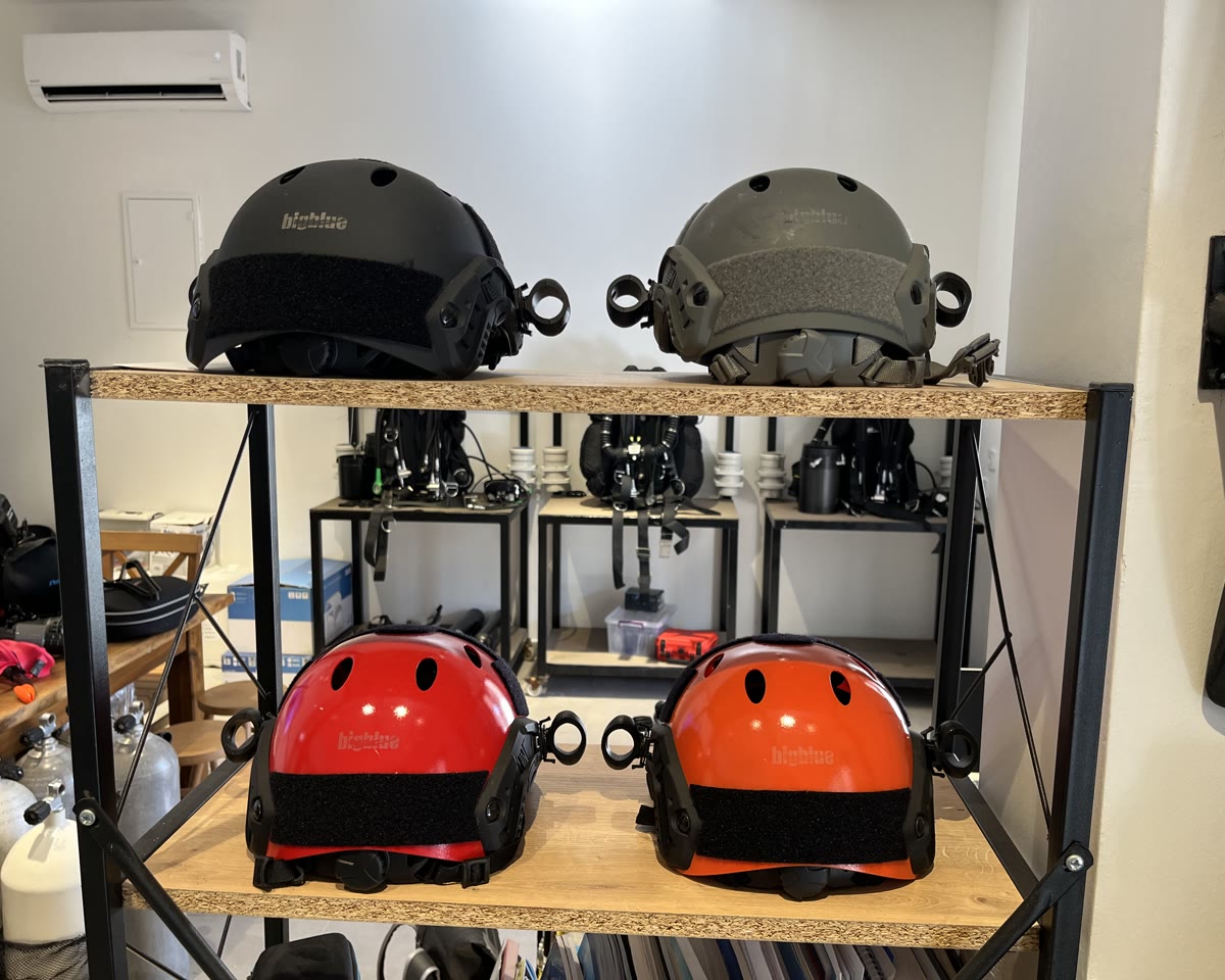 Surface-supply helmets racked in the equipment room