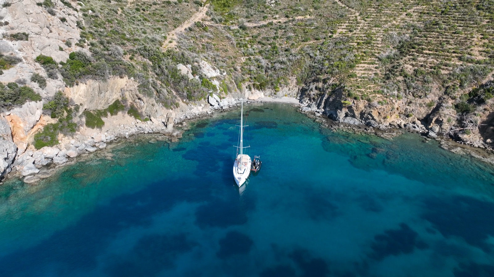 The yacht tucked into a wild cove